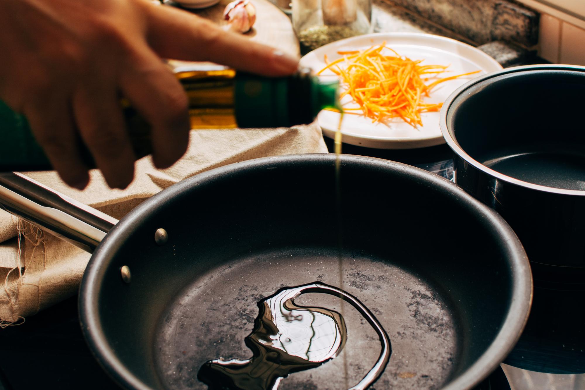 hands stirring a pot in a compact urban kitchen