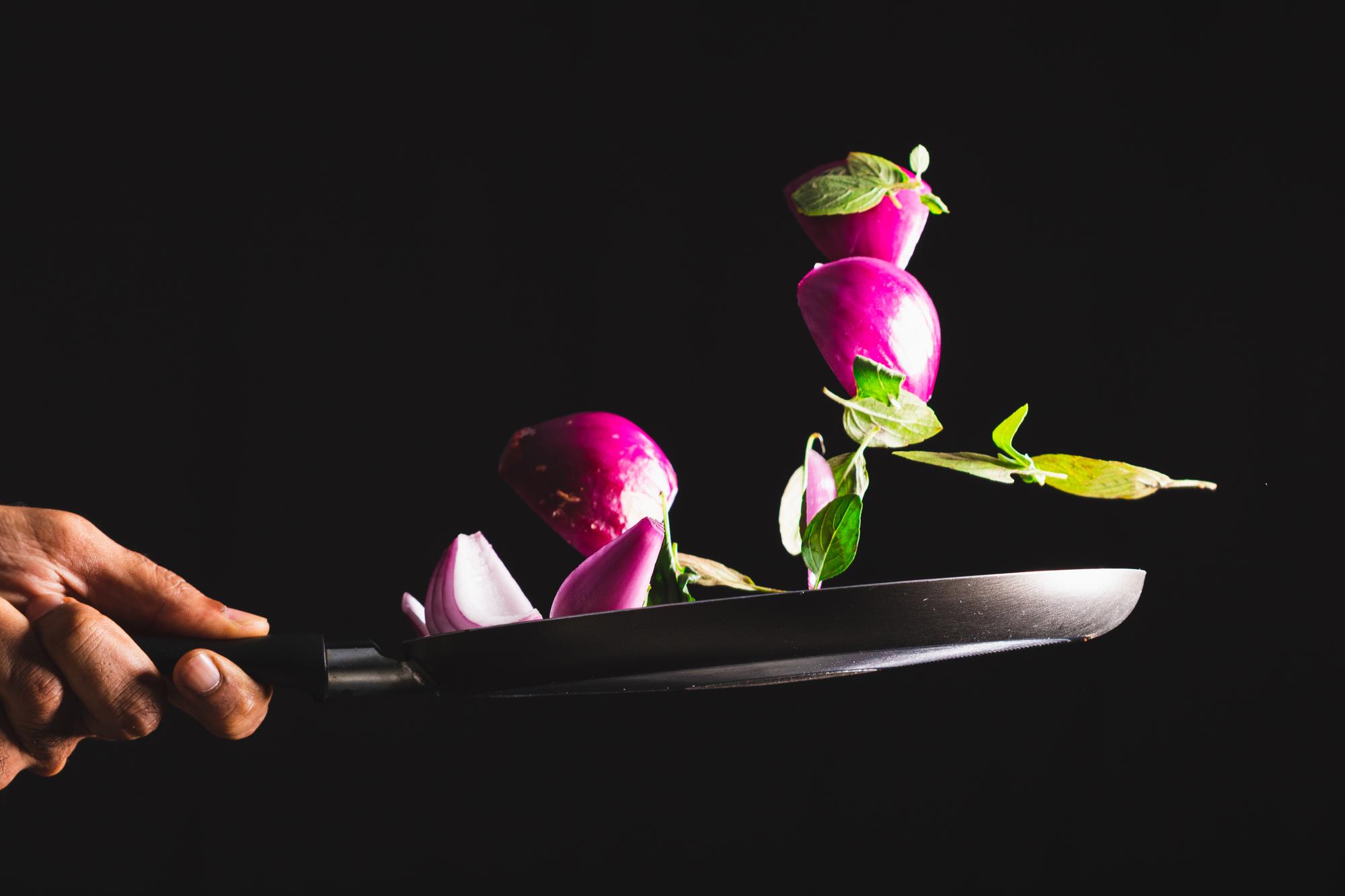 chef plating a modern dish with neon plating accents
