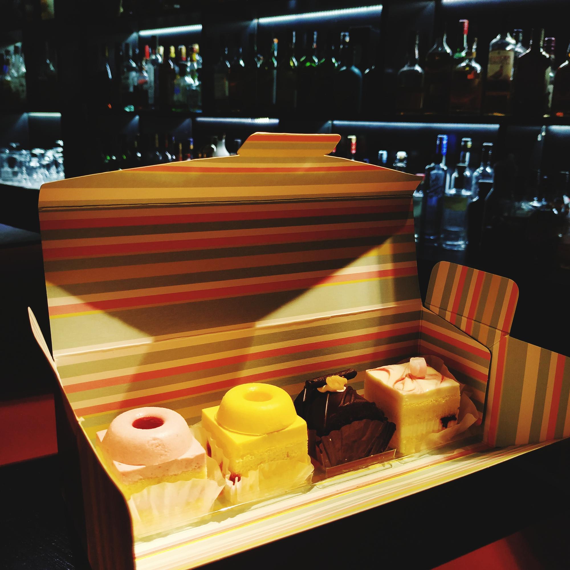 boxed tasting kit on a dark table with neon accent